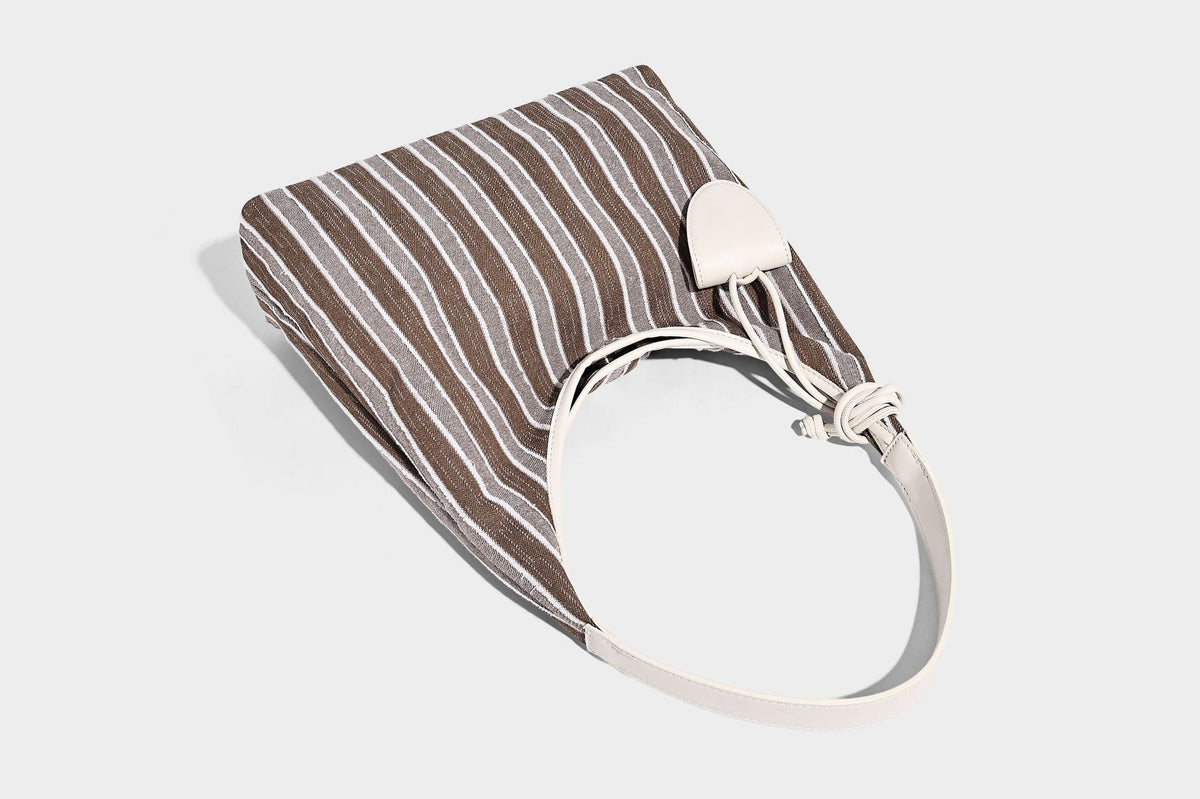 Slouchy striped canvas hobo shoulder bag with cream trim and long knotted strap, detail view 14