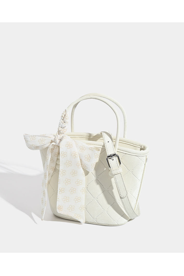 Quilted leather-look mini tote bag with printed scarf bow on braided top handle and silver-tone hardware, detail view 9
