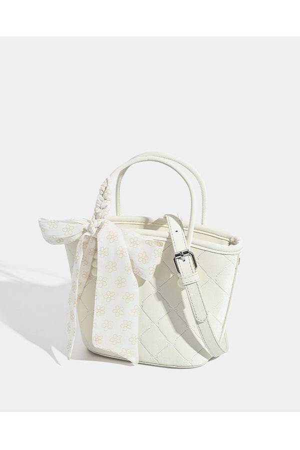 Quilted leather-look mini tote bag with printed scarf bow on braided top handle and silver-tone hardware, detail view 9