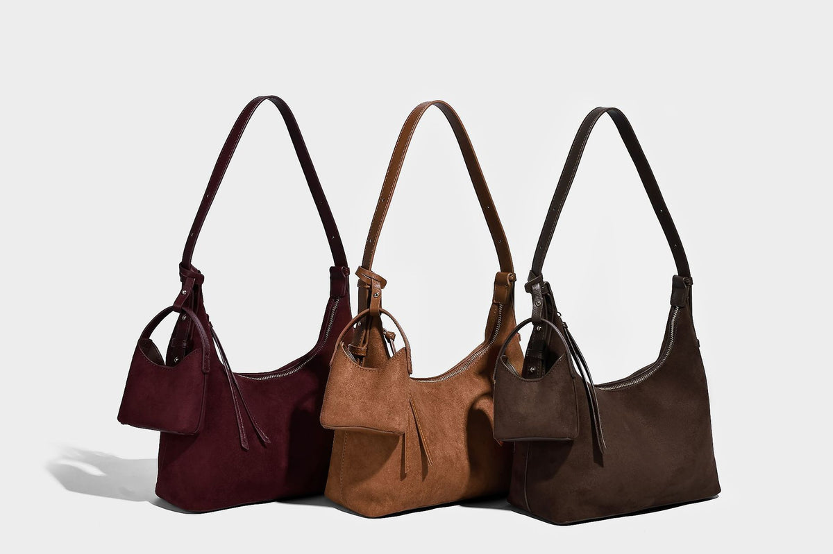 Dark brown suede-look hobo shoulder bag with top zip closure, adjustable strap, and small detachable mini pouch, detail view