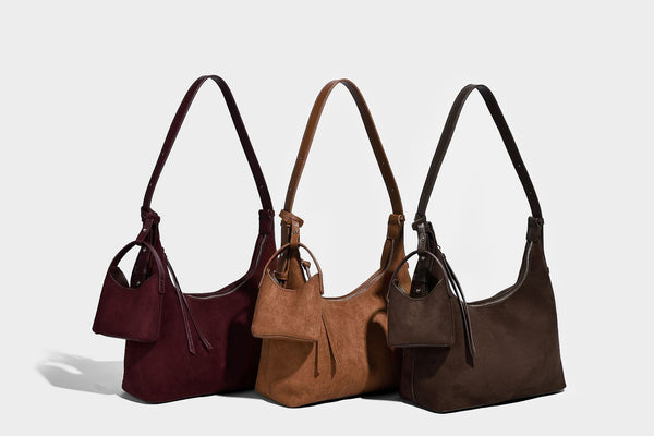 Dark brown suede-look hobo shoulder bag with top zip closure, adjustable strap, and small detachable mini pouch, detail view
