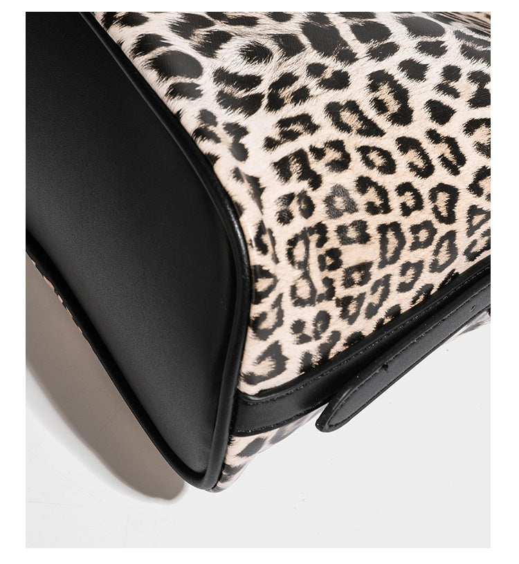 Slouchy leopard print shoulder hobo bag with black leather-look trim, tie-top closure, and single long strap, detail view 20