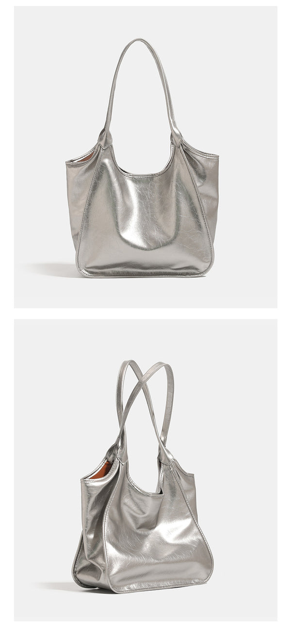 Large open-top shoulder tote bag with glossy crinkled metallic finish and long double straps, detail view 10
