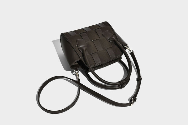 Small structured woven-panel mini tote bag with double top handles and detachable crossbody strap in matte leather-look