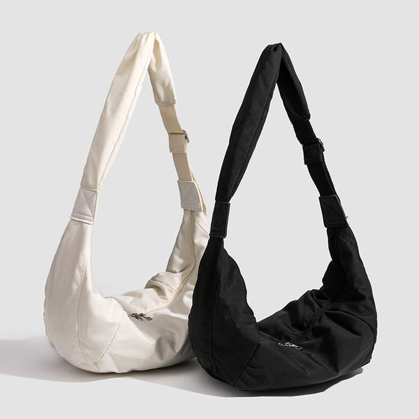 Large crescent sling shoulder bag in gathered fabric with zip closure and adjustable strap, detail view 2