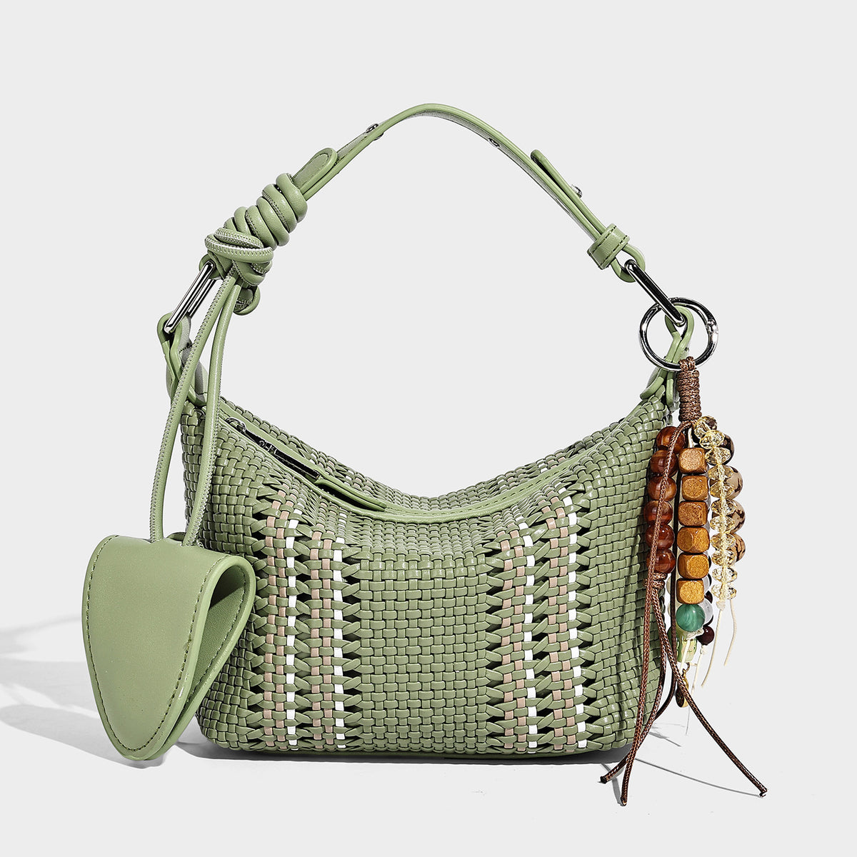 Small woven crescent shoulder bag with leather-look trim, zip closure, silver-tone ring hardware, and beaded tassel charm