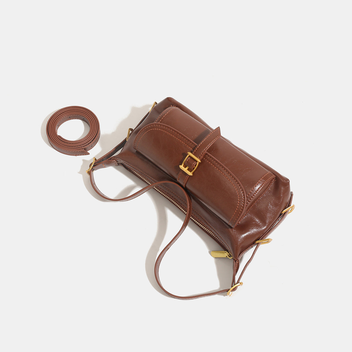 Compact glossy oil-wax leather-look shoulder bag with front buckle flap pocket and gold-tone hardware, detail view 4