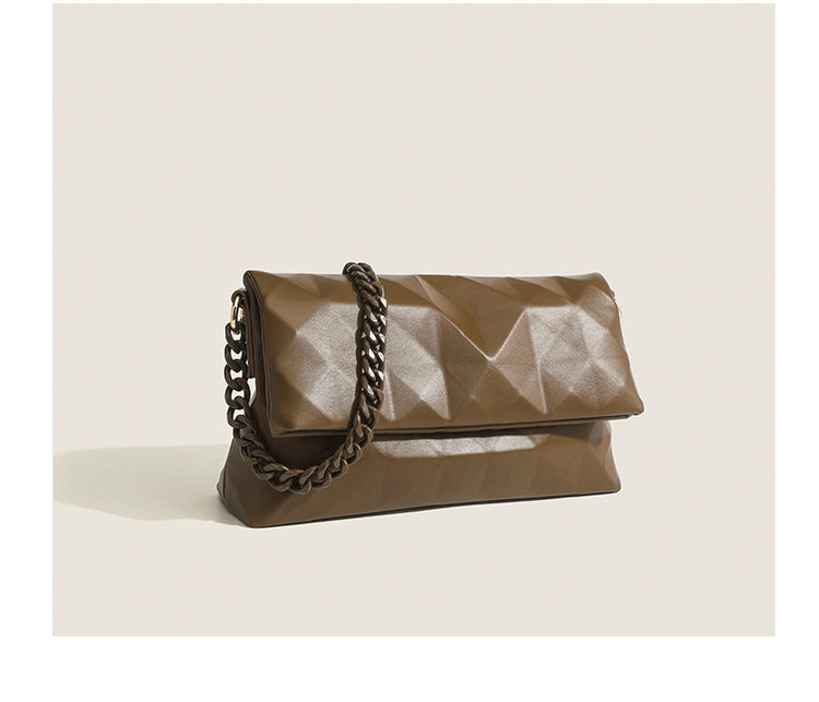 Cream white rectangular flap shoulder bag with geometric faceted surface and chunky tone-on-tone chain strap with gold-tone