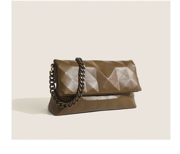 Cream white rectangular flap shoulder bag with geometric faceted surface and chunky tone-on-tone chain strap with gold-tone