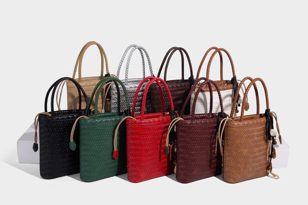 Small structured woven-texture tote bag with braided top handles and drawstring inner pouch, detail view 25