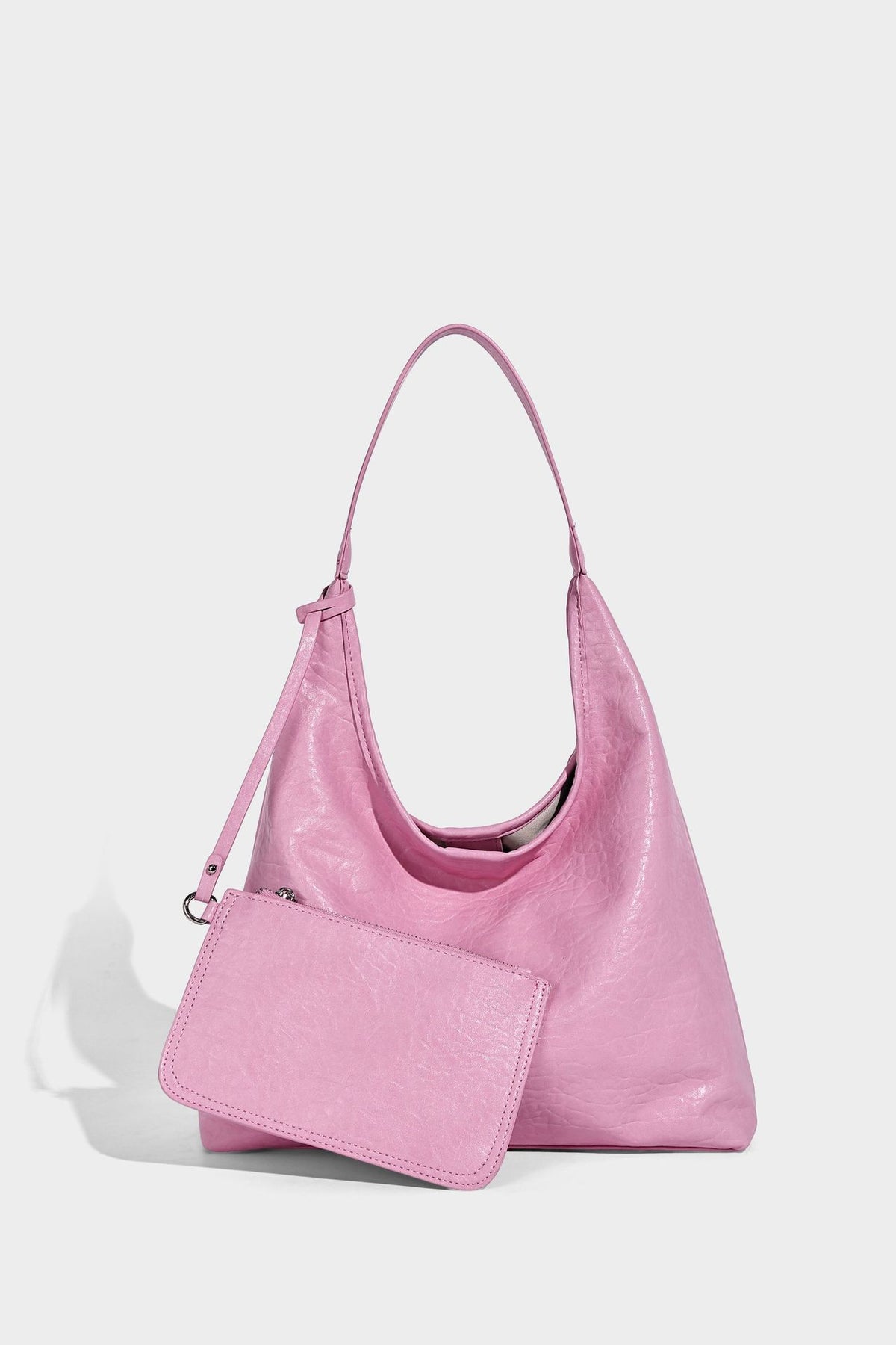 Slouchy hobo shoulder bag in pale yellow glossy pebbled leather-look finish with single shoulder strap and detachable front