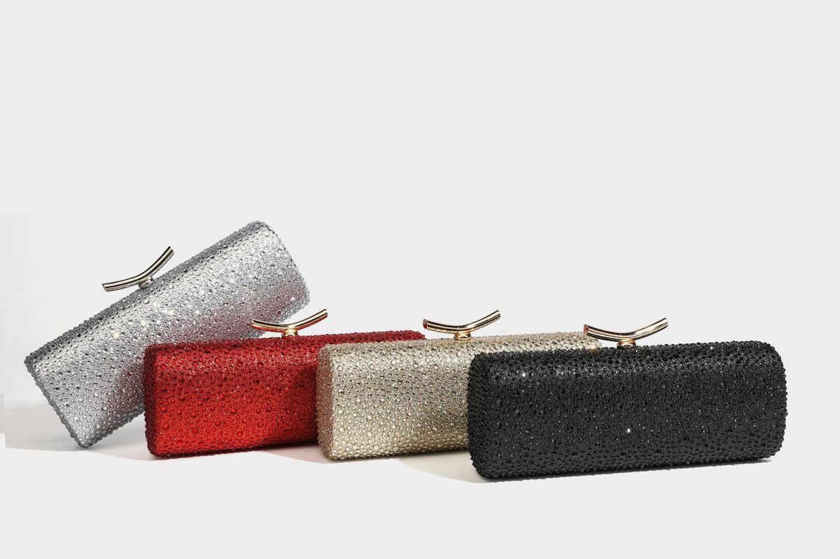 Structured rectangular hard-case clutch bag covered in all-over rhinestone crystal embellishment with curved kiss-lock top