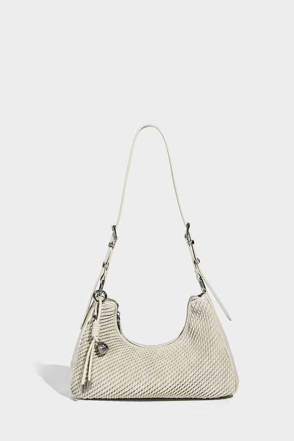 Woven crescent hobo shoulder bag with smooth side panels, zip-top closure, silver-tone charm hardware, and adjustable, detail