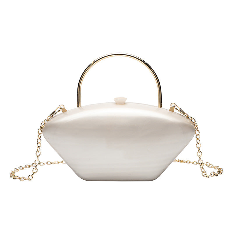 Shell-shaped pearlescent top-handle clutch bag with arched gold-tone metal handle and gold chain strap, detail view 5