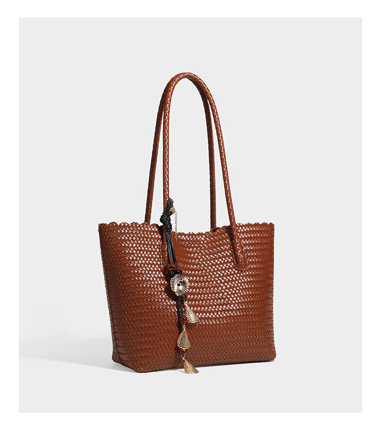 Large open-top woven leather-look tote bag in dark brown with scalloped edge, braided double shoulder straps, and decorative