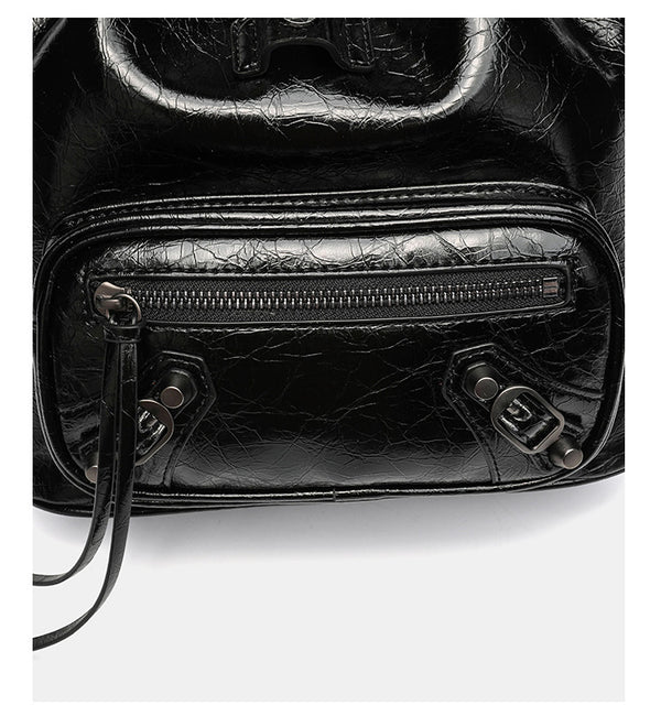 Small structured glossy leather-look convertible backpack handbag in black with flap closure, front zip pockets, metal stud
