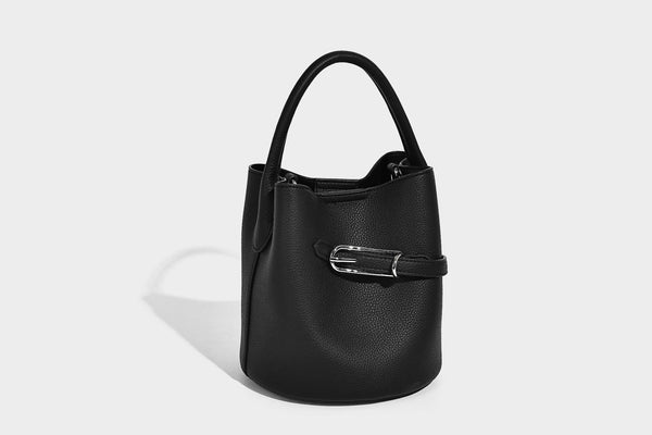 Mini pebbled leather-look bucket bag with front buckle strap, silver-tone hardware, top handle, and detachable shoulder