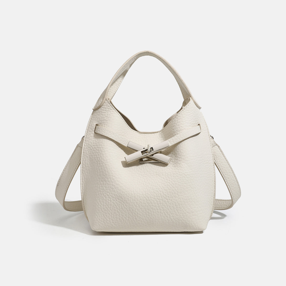 Compact pebbled leather-look shoulder bag with crossed silver-toned metal front closure, short top handle, and long, detail