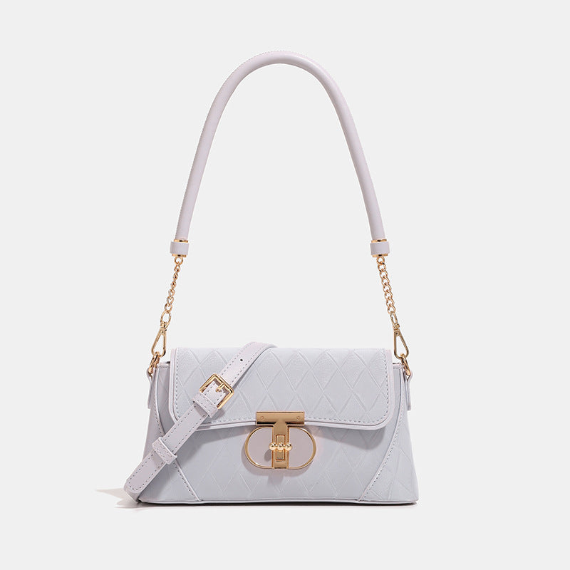 Small structured diamond-quilted flap bag with gold-tone turn-lock closure, chain shoulder strap, and cylindrical top handle