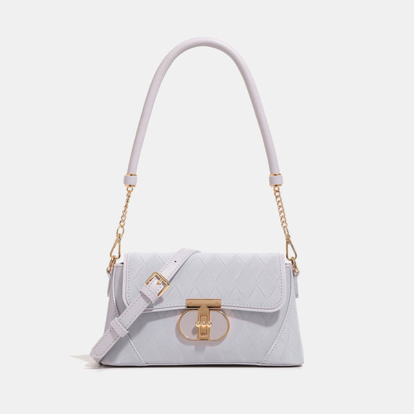 Small structured diamond-quilted flap bag with gold-tone turn-lock closure, chain shoulder strap, and cylindrical top handle