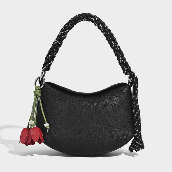 Small crescent half-moon bag in pebbled leather-look finish with braided top handle, silver-tone ring hardware, and, detail