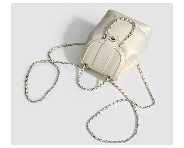 Small pearl-gloss backpack handbag with woven silver chain straps and turn-lock flap closure, detail view 13