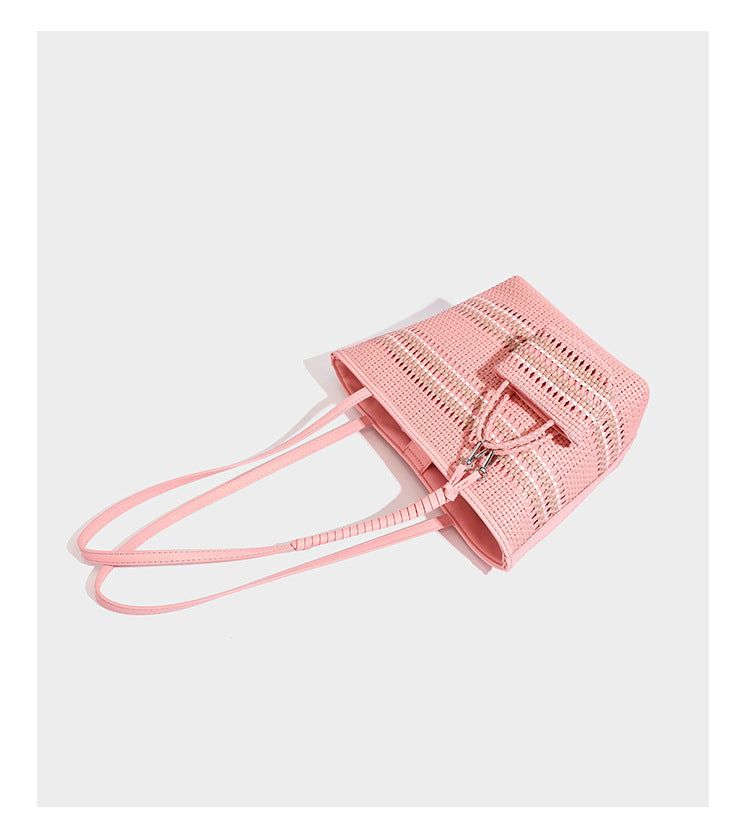 Large structured woven tote bag with striped basket-weave finish, long shoulder straps, and detachable mini pouch charm
