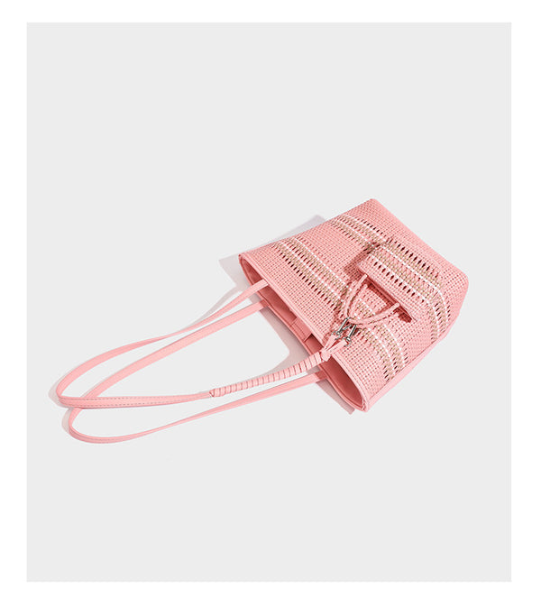 Large structured woven tote bag with striped basket-weave finish, long shoulder straps, and detachable mini pouch charm