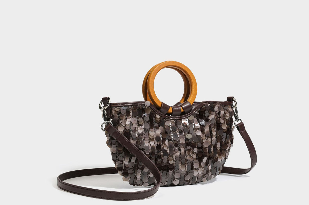 Small sequin half-moon handbag with circular wood-look ring handles and detachable leather-look shoulder strap, detail view