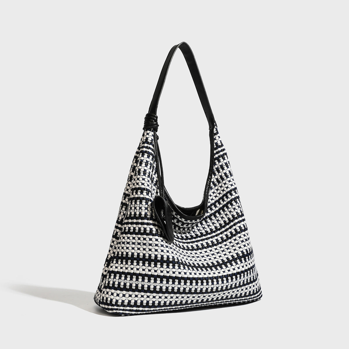 Slouchy woven stripe hobo shoulder bag with black-and-white pattern and leather-look strap, detail view 6