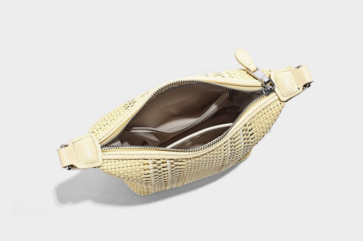 Small woven crescent shoulder bag with leather-look trim, zip closure, silver-tone ring hardware, and beaded tassel charm