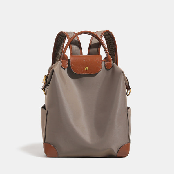 Soft rectangular nylon convertible backpack handbag with leather-look trim, snap-flap closure, top carry handles, padded