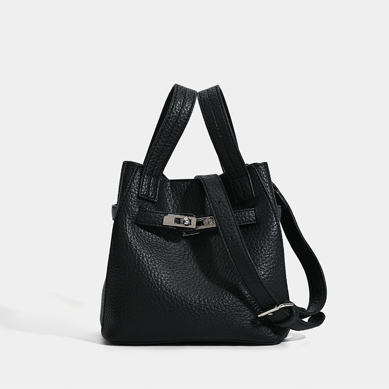 Small structured pebbled leather-look bucket bag with silver turn-lock bar hardware and dual top handles, front view