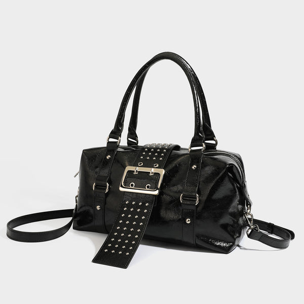 Glossy crinkled barrel handbag with silver stud buckle strap and detachable shoulder strap, front view