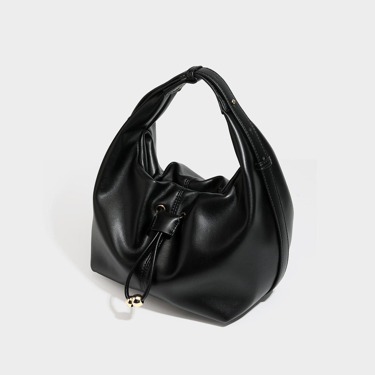Slouchy hobo bag with smooth leather-look finish, drawstring cinch closure, and gold-tone bead hardware, front view