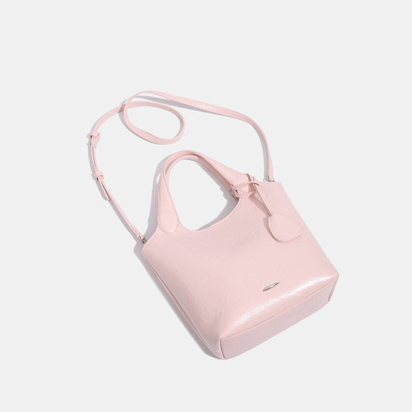 Soft glossy leather-look bucket tote bag with twin handles and detachable crossbody strap, detail view 4