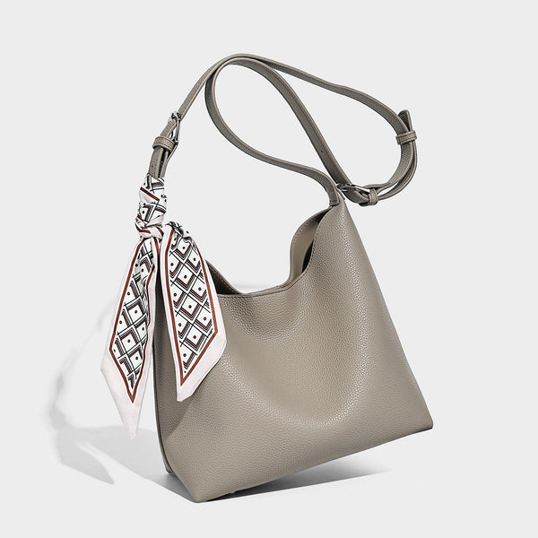 Soft slouchy hobo shoulder bag in pebbled matte finish with slim strap, silver-tone ring hardware, and knotted printed scarf