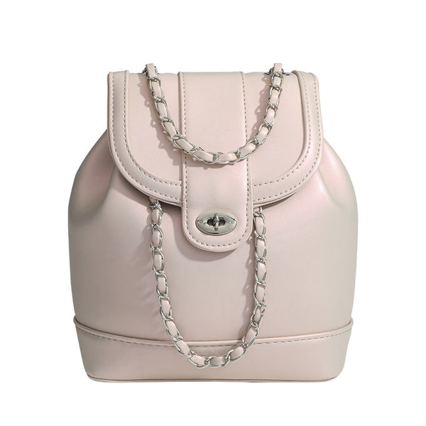 Small pearl-gloss backpack handbag with woven silver chain straps and turn-lock flap closure, detail view 5