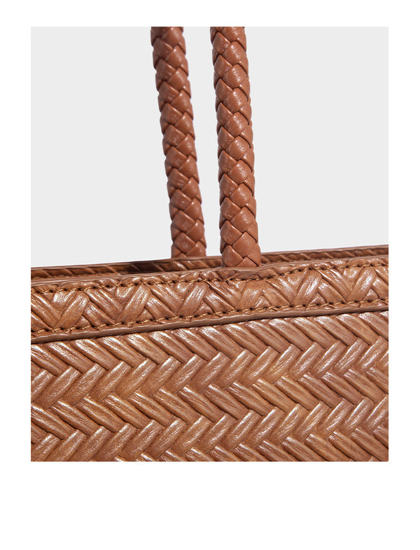 Structured woven herringbone tote bag with braided double shoulder handles in tan brown, shown with matching drawstring