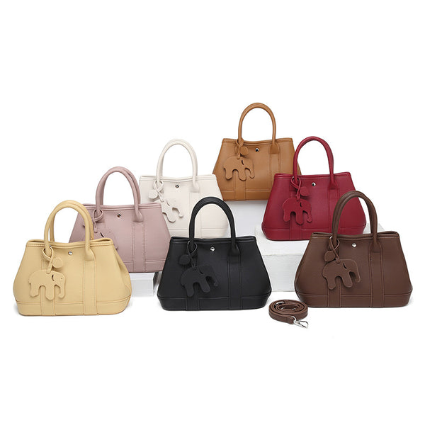 Structured pebbled leather-look top-handle tote bag with elephant charm and detachable shoulder strap, detail view 2