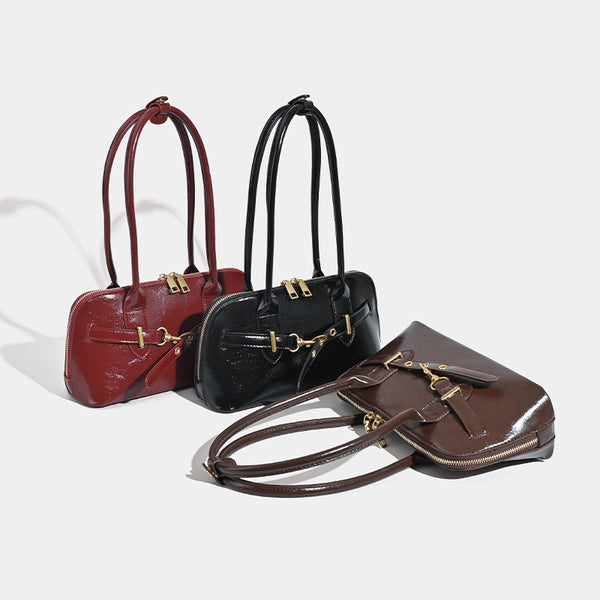 Small structured glossy leather-look shoulder bag with gold-tone buckle hardware and twin top handles, detail view 2