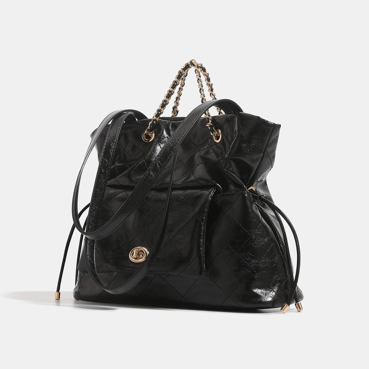 Black glossy diamond-quilted bucket tote bag with gold-tone chain accent, turn-lock front flap pocket, drawstring side ties