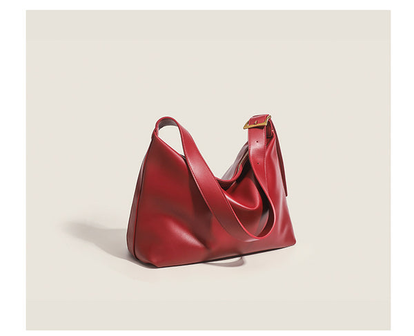 Large slouchy hobo shoulder bag in smooth leather-look finish with single long strap and gold-tone zip closure, detail view