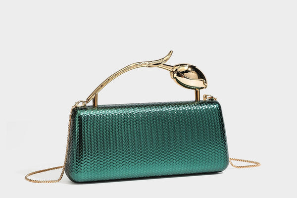 Structured rectangular metallic woven clutch bag with sculptural gold-tone leaf top handle and detachable chain strap, detail
