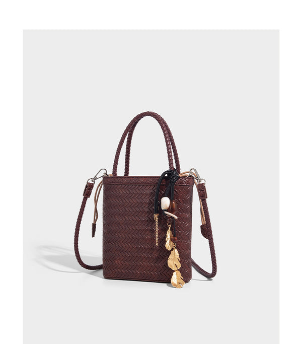 Small structured woven-texture tote bag with braided top handles and drawstring inner pouch, detail view 14
