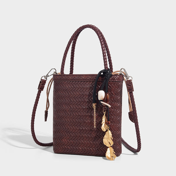 Small structured woven-texture tote bag with braided top handles and drawstring inner pouch, front view