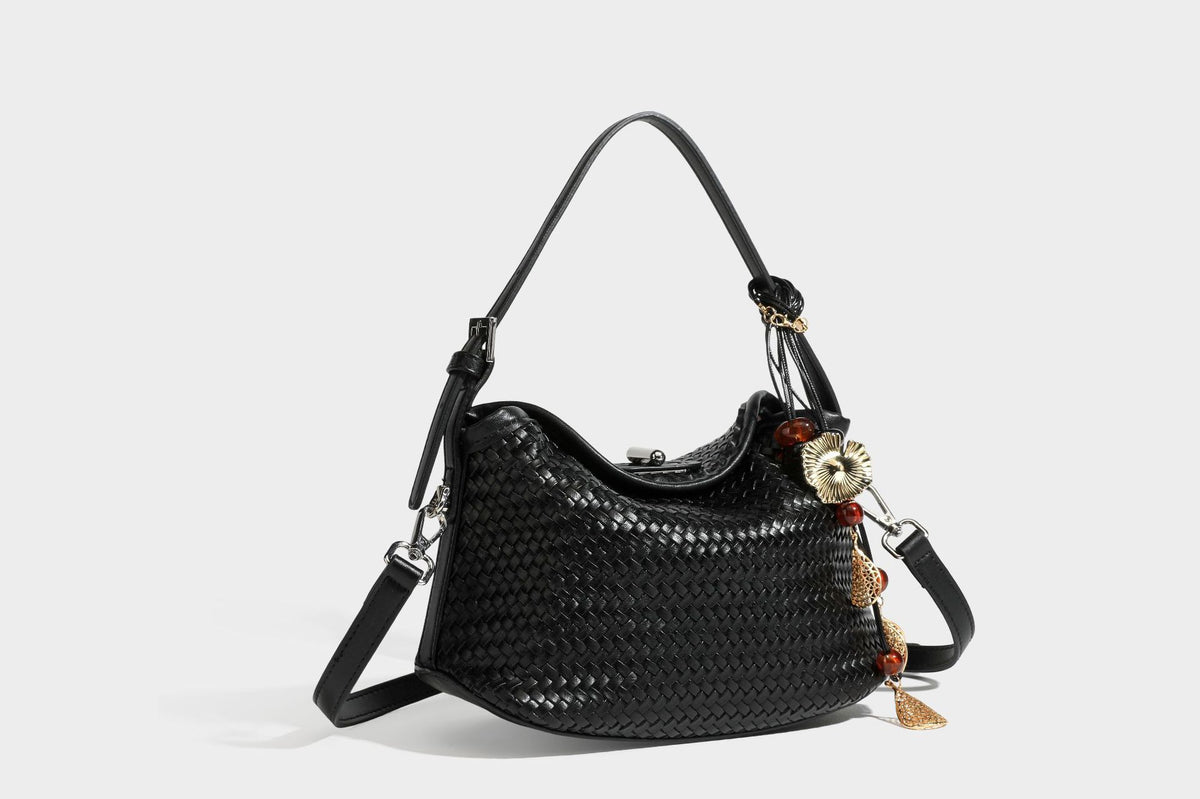 Small woven-look leather-look flap shoulder hobo bag in burgundy with silver-tone hardware and decorative tassel charm