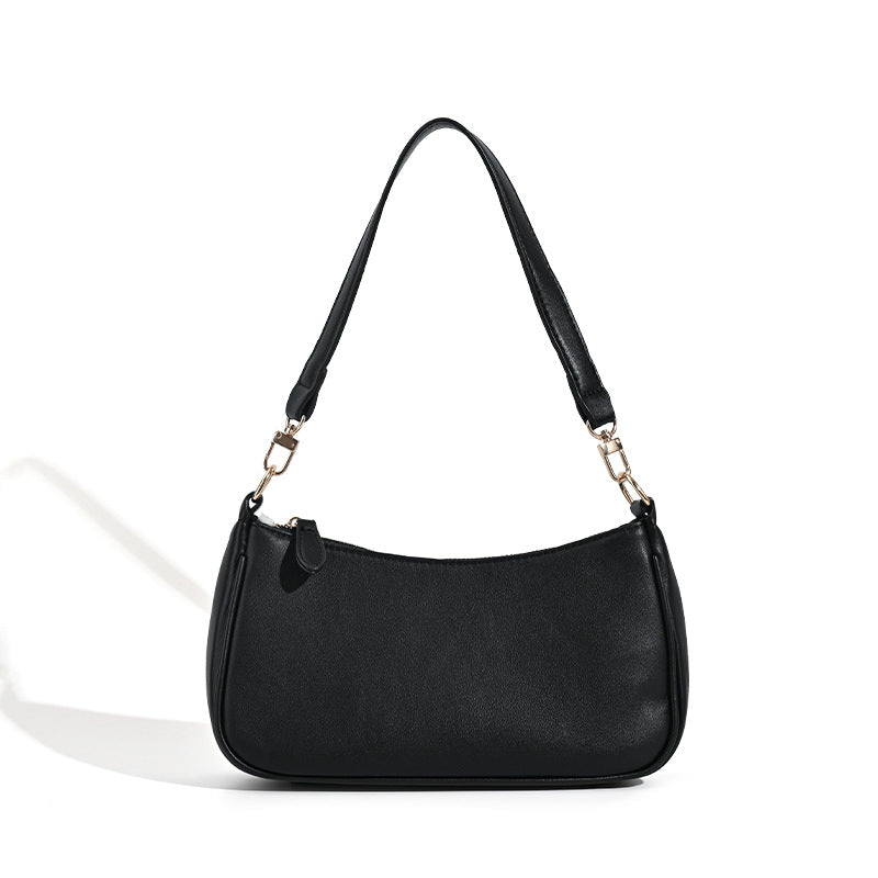 Kompakte Baguette-Schultertasche mit bogenförmiger Silhouette, strukturierter Oberfläche in Lederoptik und goldfarbenen Metalldetails, Detailansicht 5
