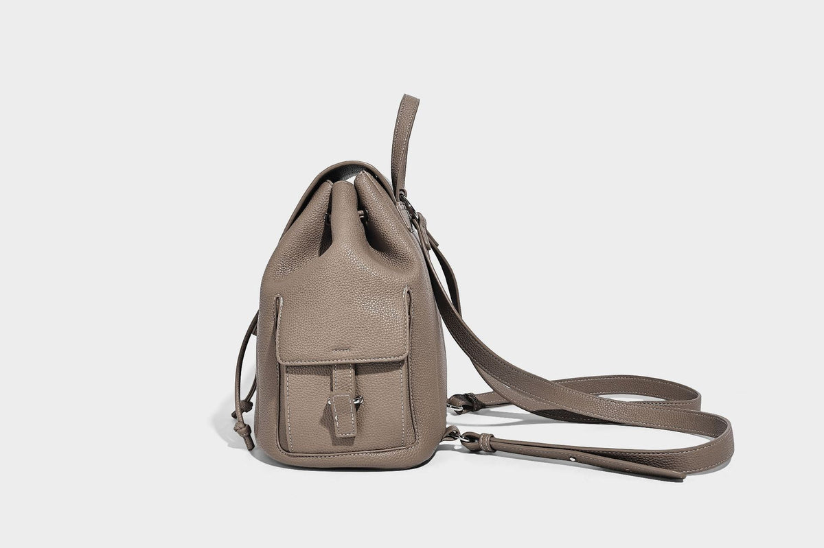 Compact pebbled leather-look flap drawstring backpack handbag with side pockets, top handle, and silver-tone hardware, detail