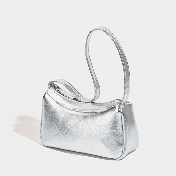 Compact curved silver metallic shoulder bag with top zip closure and slim single strap, detail view 2